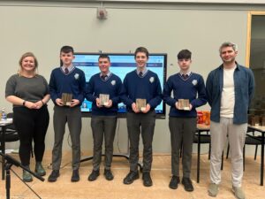 Person holding a DSLR camera capturing a vibrant sunset. Photography tips.